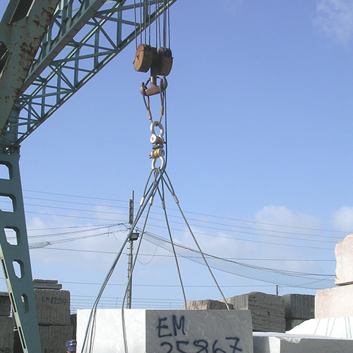 A stone block is lifted and weighed